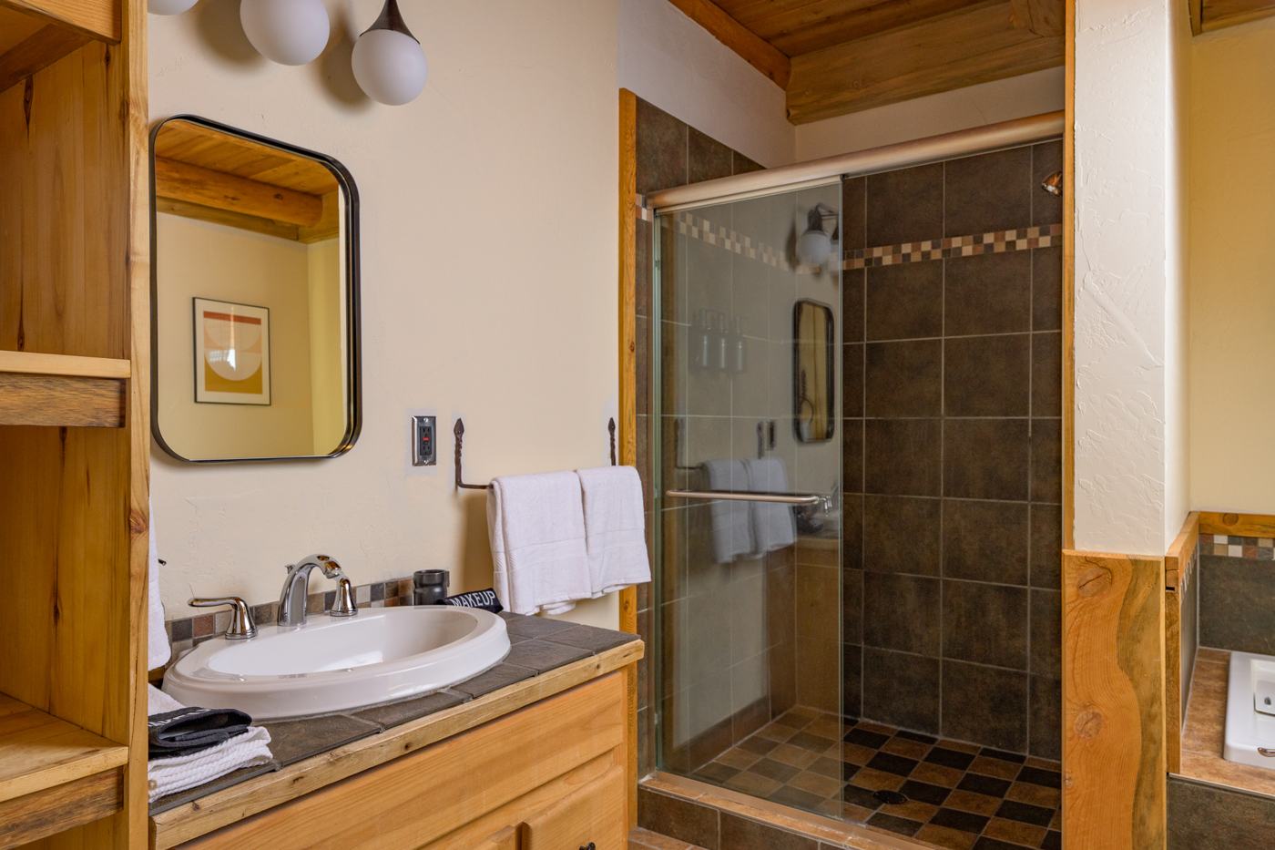 Bathroom with vanity and walk-in tiled shower